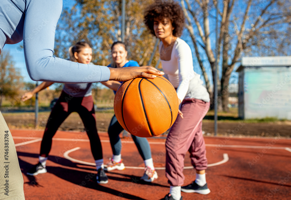 Diverse group of young woman having fun playing recreational basketball outdoors. Diverse group of young woman having fun playing recreational basketball outdoors.