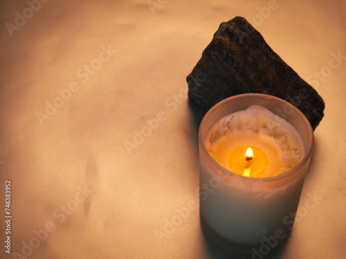 Scented candle with stones related to spa or relaxation photo