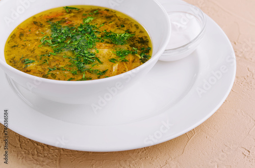 parsley noodle soup on white bowl