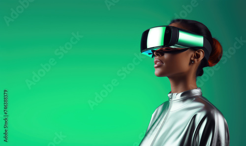 A woman wearing virtual reality headset glasses on a green background. Concept of technology, augmented reality, science, engineering. Copy space for text, advertising, message, logo  © CFK