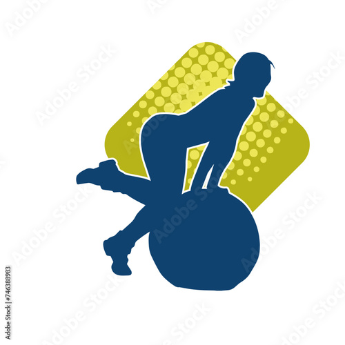 Silhouette of a slim sporty woman doing pilates exercise using gym ball. Silhouette of a sporty female doing physical exercise using fitness ball. 
