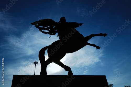Silhouette of Statue Of Prince Diponegoro against blue sky at Merdeka Square in Jakarta, Indonesia. 