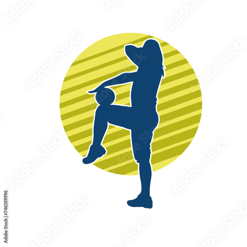 Silhouette of a slim sporty woman doing pilates exercise using gym ball. Silhouette of a sporty female doing physical exercise using fitness ball. 