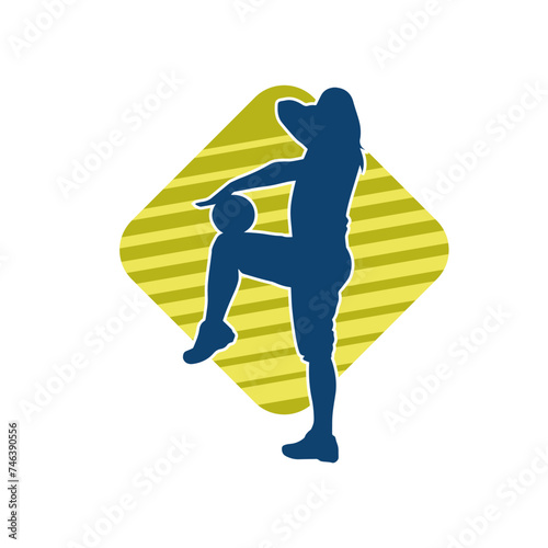 Silhouette of a slim sporty woman doing pilates exercise using gym ball. Silhouette of a sporty female doing physical exercise using fitness ball. 