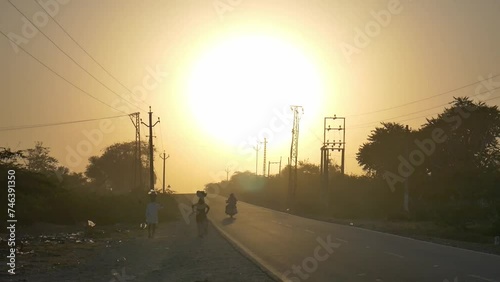 Evening time of rajasthan. A desi couple going home from work in evening time near by sambhar lake, evening of villages in rajasthan. photo