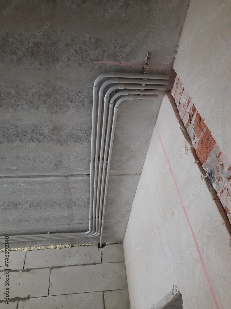 Installation of plastic pipes for the electrical network. Stock Photo Adobe Stock