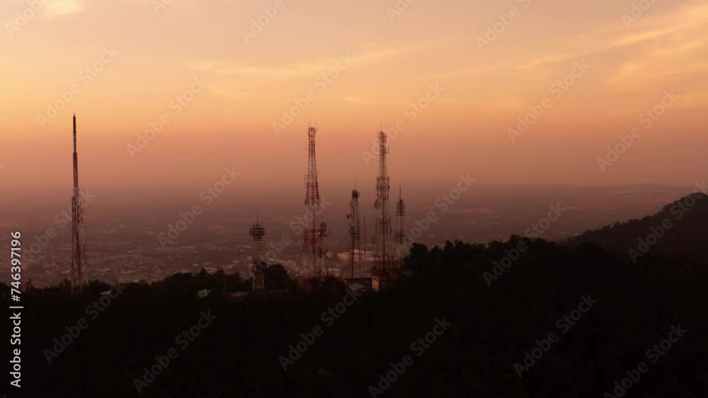 Aerial view of telecommunication towers standing on top of mountain at sunset, Ark shot 4k footage. Aerial view of telecommunication towers standing on top of mountain at sunset, Ark shot 4k footage.