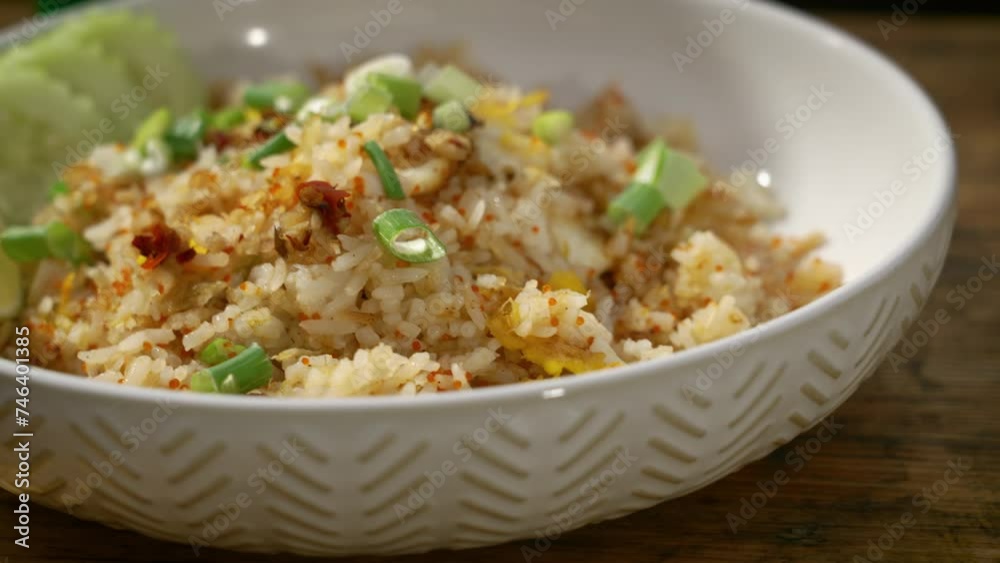 Plated crab fried rice topped with chopped green onions, slider close up 4K Plated crab fried rice topped with chopped green onions, slider close up 4K