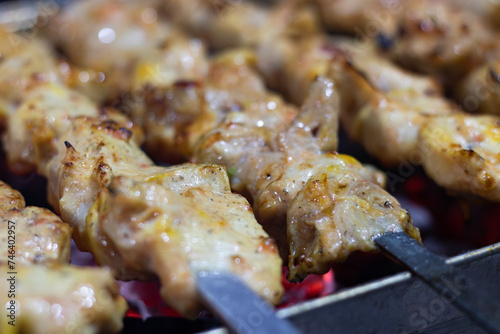 Charred Perfection: Succulent Chicken Kebab Sizzles on Charcoal Fire close up photo