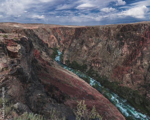 Landscape with panorama of the Black Charyn Canyon in Kazakhstan in summer under a cloudy sky photo