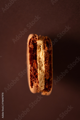 brown coffee macaron on a brown background
