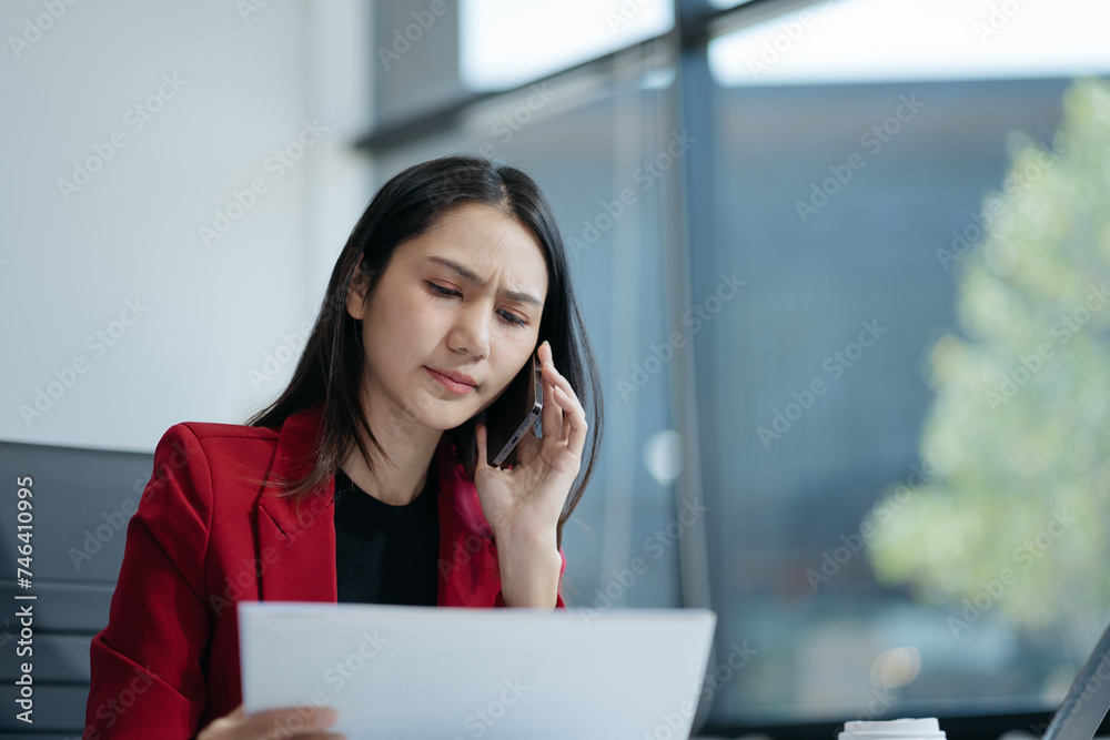Serious business woman concentrating on his paper work at the table at office. Serious business woman concentrating on his paper work at the table at office.