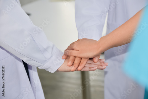 Doctors and nurses in a medical team stacking hands.Concept Teamwork in hospital for success work and trust in team © Suriyo