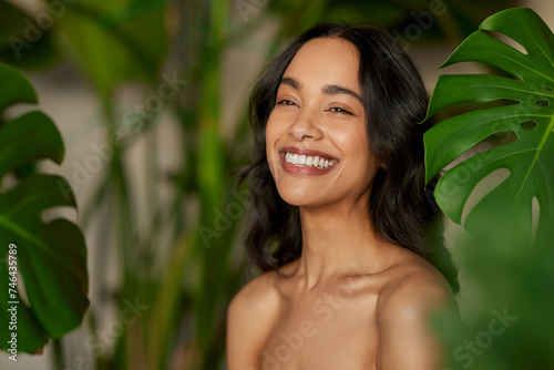 Beautiful natural woman with monstera leaves