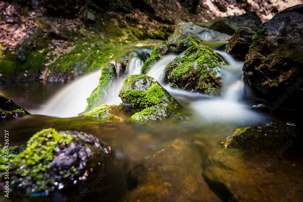 Waterfall between rocky stream in the mountains Waterfall between rocky stream in the mountains