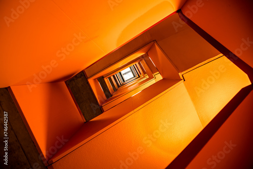 Принти на полотні Orange rectangular spiral staircase with vanishing point