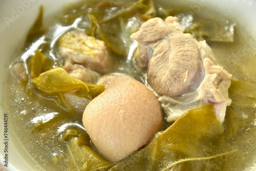 boiled pork leg and belly with cowa leaf soup on bowl photo