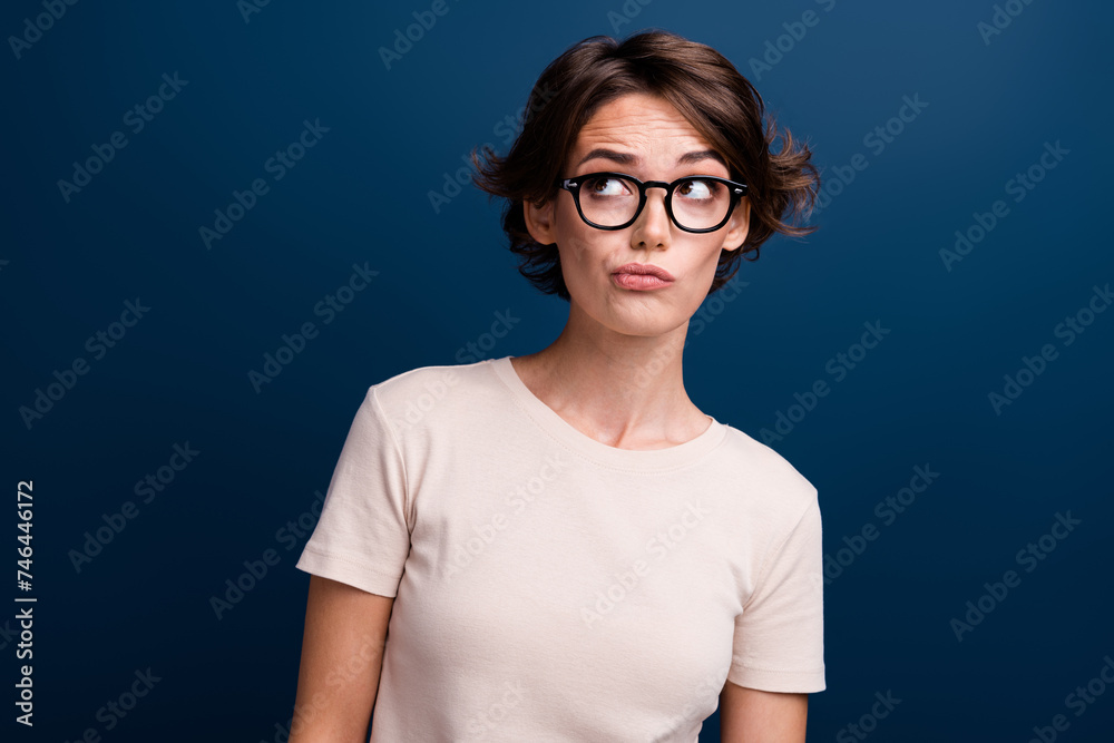 Fototapeta premium Photo portrait of lovely young lady look skeptical dislike empty space wear trendy white garment isolated on dark blue color background