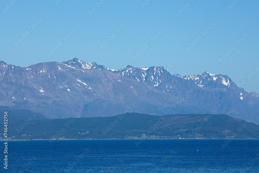 View of mountains with snow on peaks from Lyngen over fjord, Norway. 