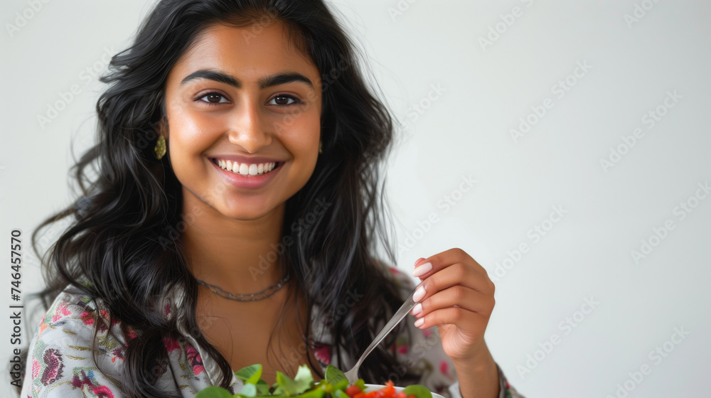 Portrait of a smiling 25+ indian woman enjoying a salad Portrait of a smiling 25+ indian woman enjoying a salad