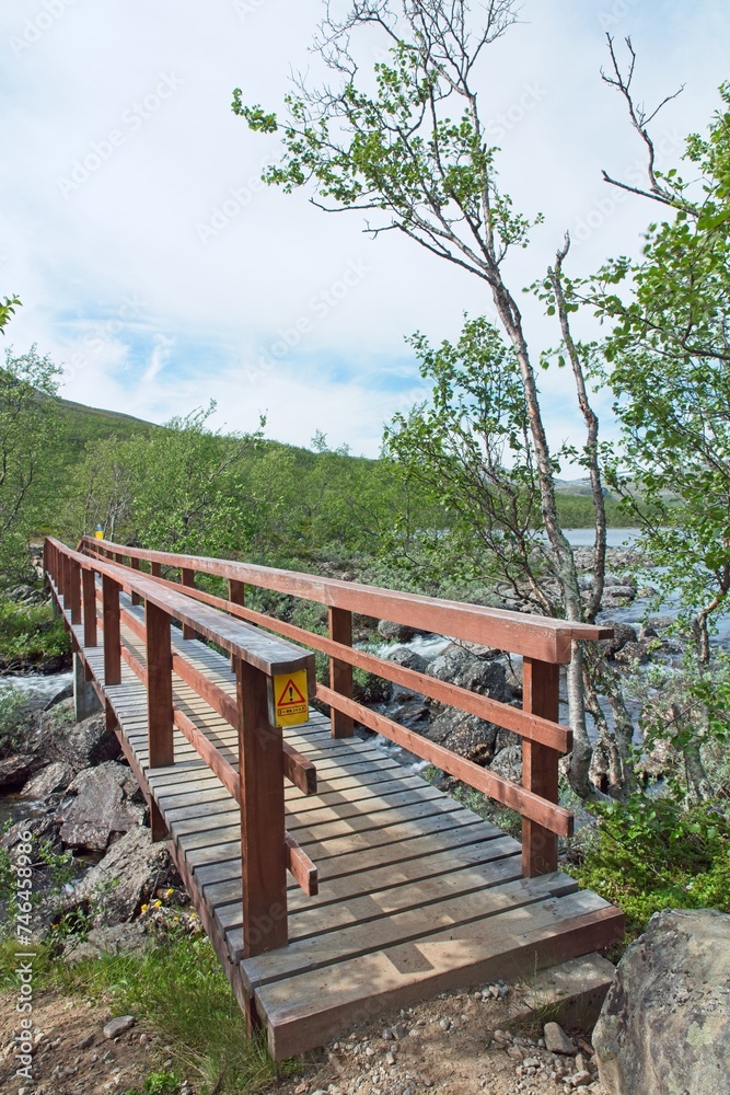 Wooden bridge over Siilaskoski rapids in summer, Kilpijärvi, Enontekiö, Lapland, Finland.