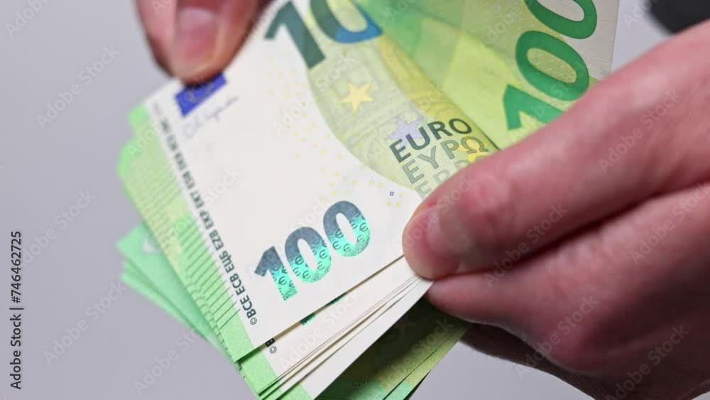 Close up of female hands counting 100 euro bills