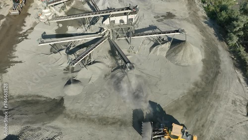 Aerial drone video of Gravel separator machine separates stone material into various fractions. Stone crusher plant machine. Conveyor belt in work process. Extraction of aggregates or gold from river photo