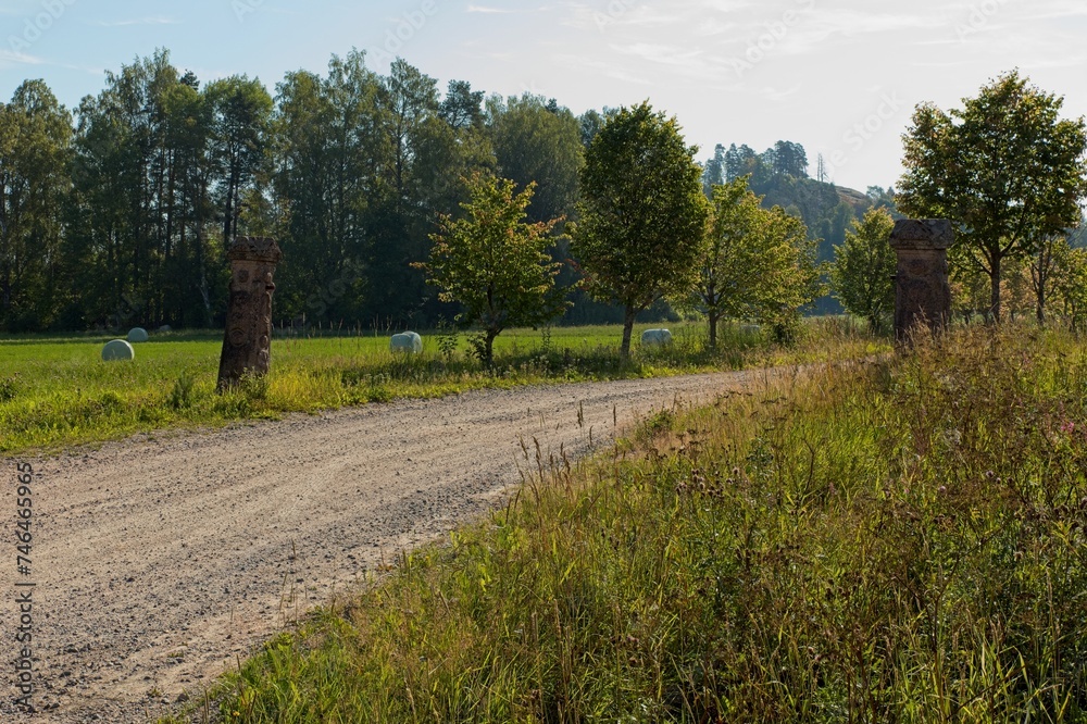 Obraz premium Rural gravel road to Hakoinen Castlehill in summer, Hakoinen, Janakkala, Finland.