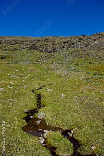 View of stream by the gravel road up the Kåfjord valley, Birtavarre, Norway. photo