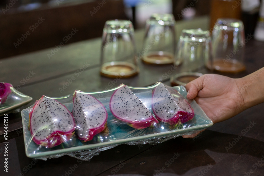 selective focus, specially selected dragon fruit Wrapped with clear plastic. fruit on ceramic plates Prepared for after lunch for customers.