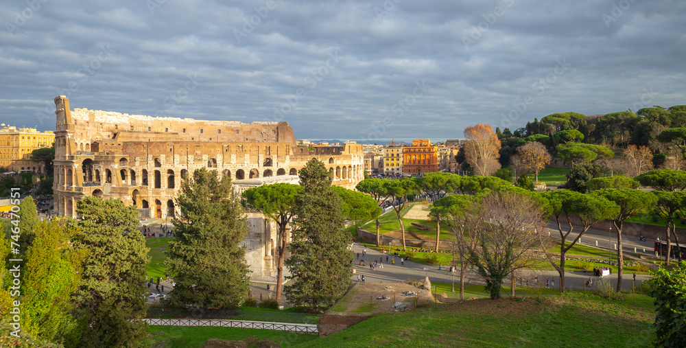the colosseum under golden sunshine in Rome, Italy, tourist, travel, header photo