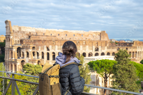 an asian girl looking at the colosseum from distance in Rome, Italy, tourist, travel