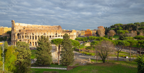 the colosseum under golden sunshine in Rome, Italy, tourist, travel, header photo