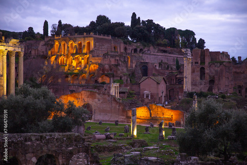 The ruins of the Roman Forum with light on at sunset  in Rome, Italy photo