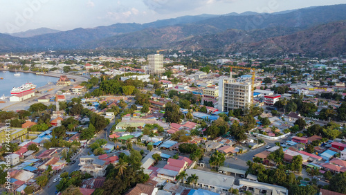 Scenic aerial landscape view of the capital city of Dili  Timor-Leste in Southeast Asia with inner city houses  buildings  hills and a glimpse of ocean