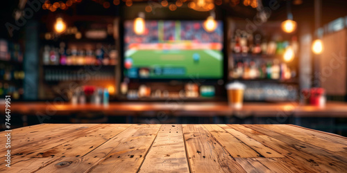 Empty wooden counter in sports bar or pub with blurred  TV displays with sporting events at the bar background photo