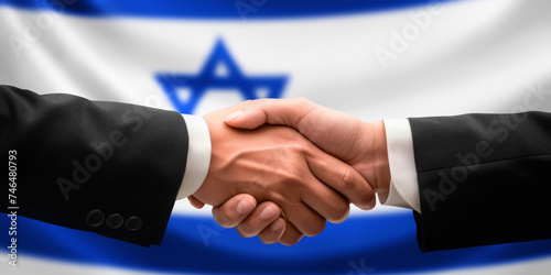 Businessman and diplomat in suits clasp hands for handshake over Israel flag, agree on united success in trade, diplomacy, cooperation, negotiation, support, teamwork in commerce, gesture of greeting