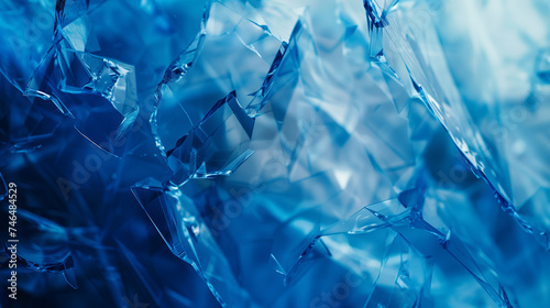 Blue abstract background with shards of broken glass for design..
