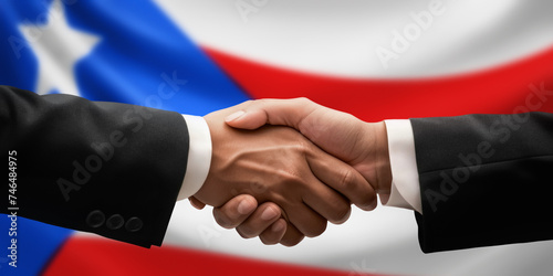 Businessman, diplomat in suits clasp hands for handshake over Puerto Rico flag, agree on united success in trade, diplomacy, cooperation, negotiation, teamwork in commerce, gesture of greeting