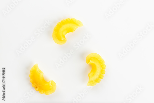 Creste Di Gallo raw, dry Italain pasta on a white background. Rooster scallop. Top view. photo