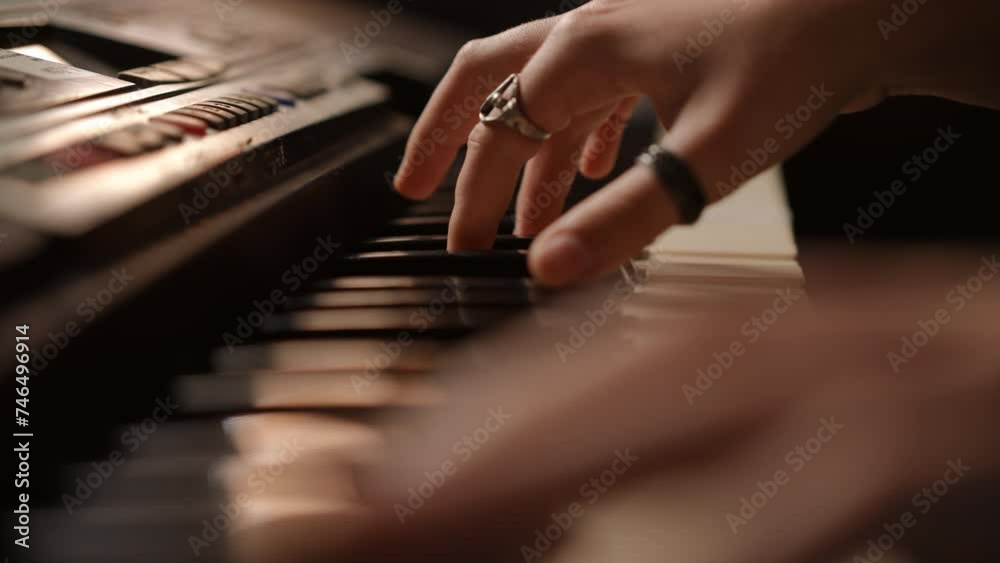 Close-up. Female hands play the synthesizer