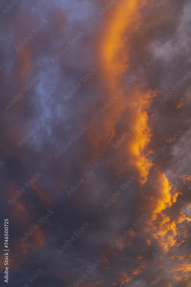 evening sky at sunset with yellow and purple cumulus and perispheric clouds