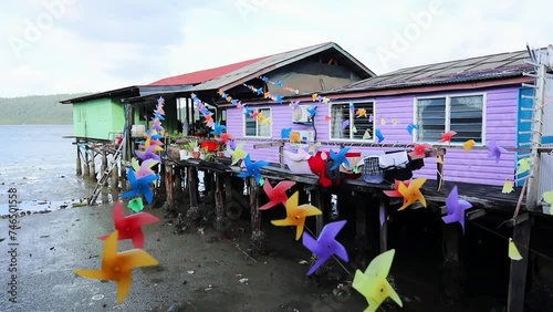Fishing village houses over the water garbage poor areas in Sabah province in Malaysia photo