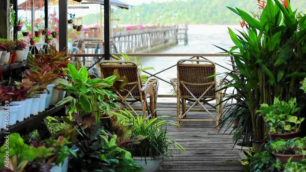 Wooden pier with wooden chairs flowers and sea view South East Asia Wooden pier with wooden chairs flowers and sea view South East Asia