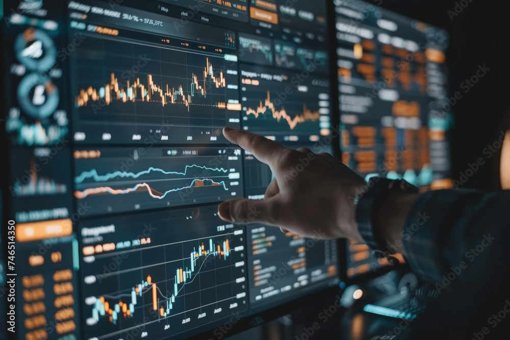 Trading stocks, crypto, on a board screen and an investor's hand pointing at the screen. Trading stocks, crypto, on a board screen and an investor's hand pointing at the screen.