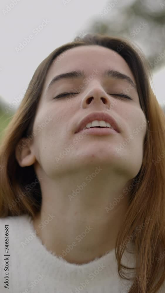Closeup of face of young woman breathing heavily and laughing outdoors Closeup of face of young woman breathing heavily and laughing outdoors