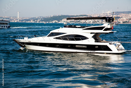 Luxury yacht boat cruising in the clean and deep blue waters of the Bosphorus, in Istanbul Turkey