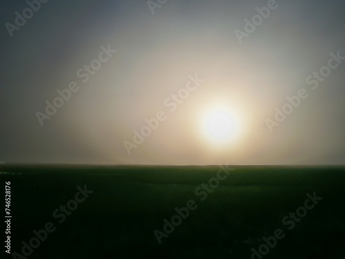 sunset in the evening over a field at dusk without people