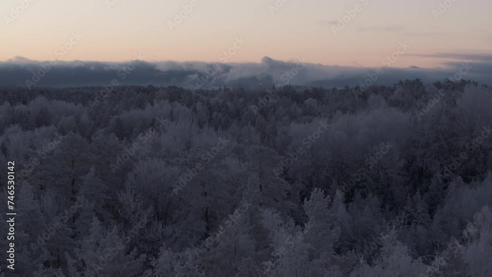Sunrise over a frozen forest covered by snow and ice captured with drone. Original file quality, 4K, DLOG, ProRes HQ. Sunrise over a frozen forest covered by snow and ice captured with drone. Original file quality, 4K, DLOG, ProRes HQ.