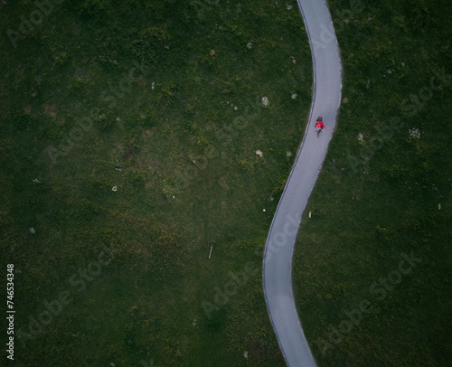 Aerial view of a man biking on a wavy path